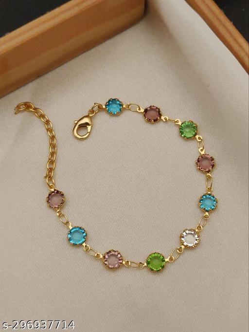 a gold bracelet with multi colored stones